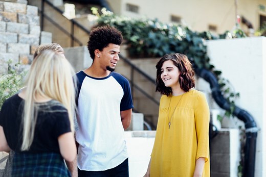 3 young people talking and smiling